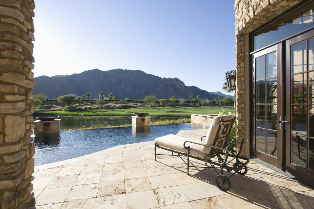 Long canal-like infinity pool on the edge of a golf course. Long canal-like infinity pool on the edge of a golf course.