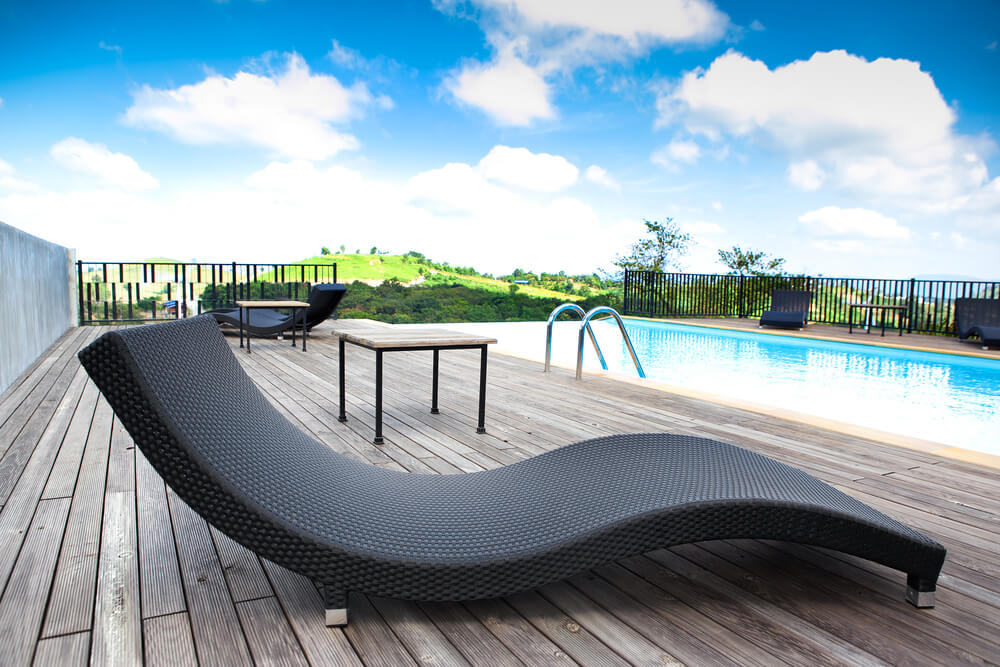 Infinity pool with wood deck overlooking valleys and small hills. Infinity pool with wood deck overlooking valleys and small hills.