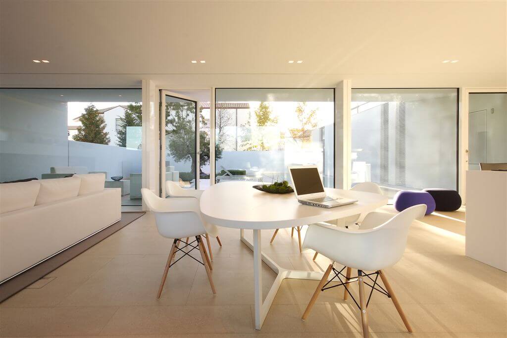 Unique curved dining table set between kitchen area and front living room. Unique curved dining table set between kitchen area and front living room.