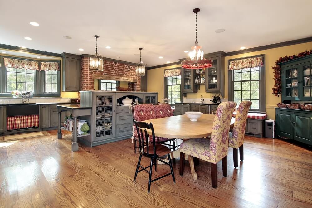 Traditional kitchen featuring a range of textures on every wooden surface, unified by light natural hardwood flooring. Traditional kitchen featuring a range of textures on every wooden surface, unified by light natural hardwood flooring.