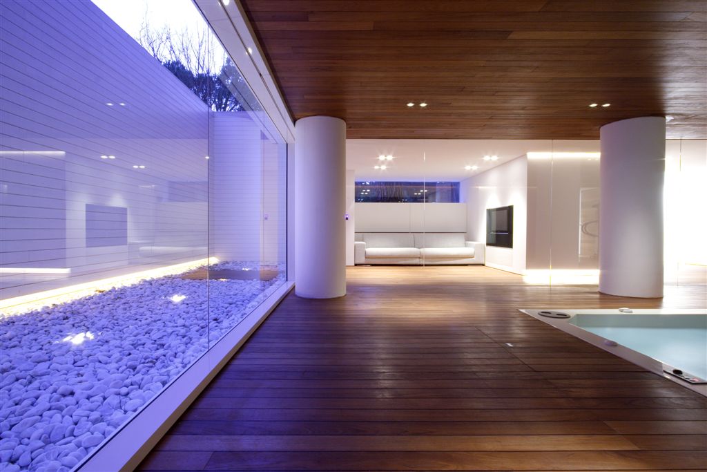 Lower level pool room with relaxing area in background, large white pillars punctuating all-wood matching floor and ceiling. Lower level pool room with relaxing area in background, large white pillars punctuating all-wood matching floor and ceiling.