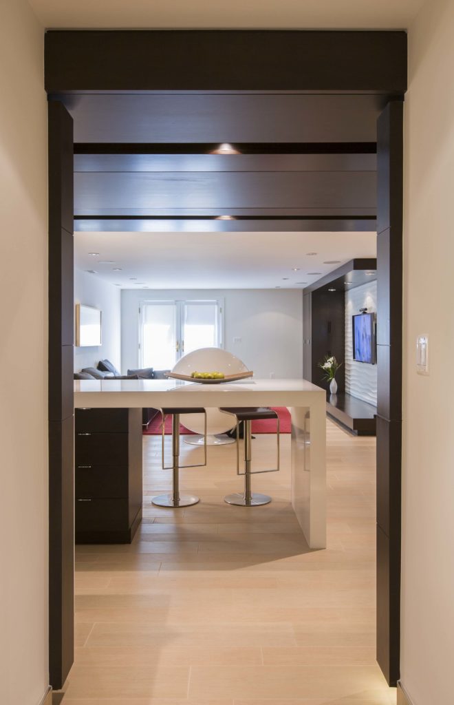 View from inside kitchen, overlooking dining counter with living room in background. View from inside kitchen, overlooking dining counter with living room in background.