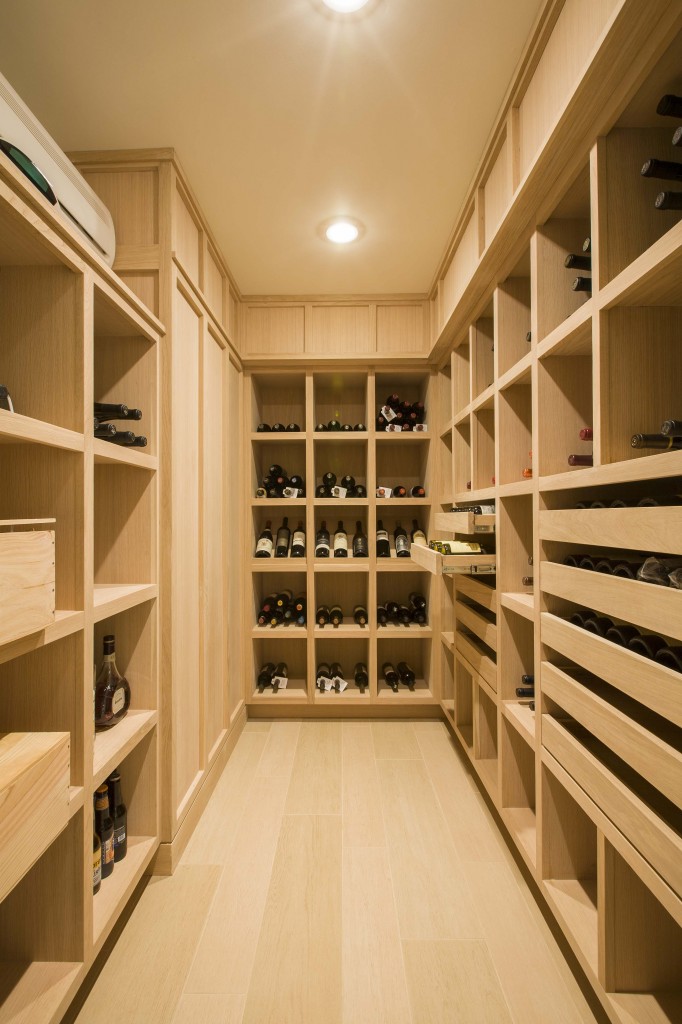 Wine cellar featuring extensive use of light natural wood matching the flooring throughout basement level. Wine cellar featuring extensive use of light natural wood matching the flooring throughout basement level.