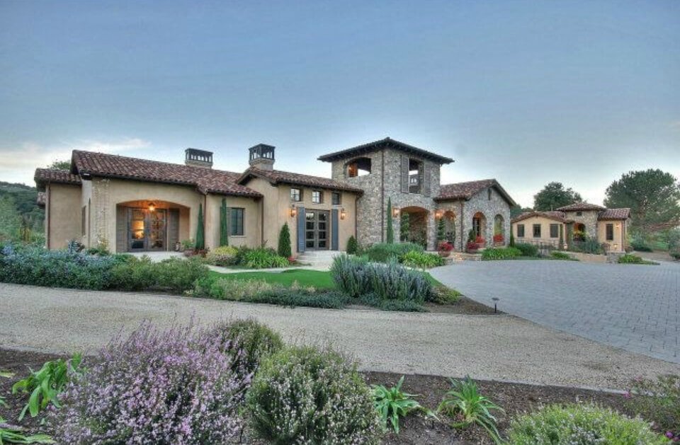 Panoramic view of the home from the front. The middle stone tower features a covered patio with great views. Panoramic view of the home from the front. The middle stone tower features a covered patio with great views.