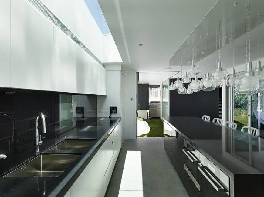 A large skylight is the main source of the light in this sleek, minimalist kitchen during the day, but in the evening these fun, bubble-shapes lights fill the room with a soft, glowing light.