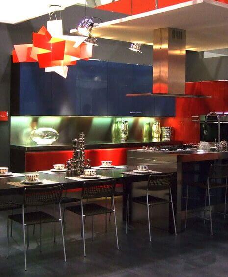 In such a modern, colorful kitchen this angular chandelier is a perfect fit. The many layers and pieces layer to create a warm glow that emanates from within and lights the table below well.