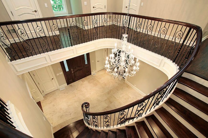 a view from the top of the staircase down the rich polished stairs and into the - Foyer Tile Design Ideas a view from the top of the staircase down the rich polished stairs and into the - Foyer Tile Design Ideas