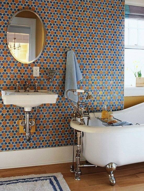 This bathroom features a wall covered in tile that forms a unique pattern. The blues and brown color works together to contribute to a calming atmosphere, white the clawfoot tub and floating sink add classical appeal. There is a large window near the head of the tub, which lets in light for the room. This bathroom features a wall covered in tile that forms a unique pattern. The blues and brown color works together to contribute to a calming atmosphere, white the clawfoot tub and floating sink add classical appeal. There is a large window near the head of the tub, which lets in light for the room.