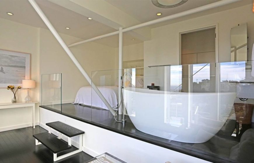 From another angle, we can see lamps and other small displays adding a soft, lived-in touch to the otherwise modern layout. There are no personal photos to be seen, instead replaced by art.