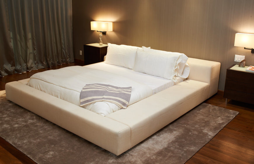 The sheer size of this bed frame makes the bed the focal point of the room, and the texture in the area rug furthers this effect. Plenty of lamps ensure that even during an evening showing, this room has plenty of light.