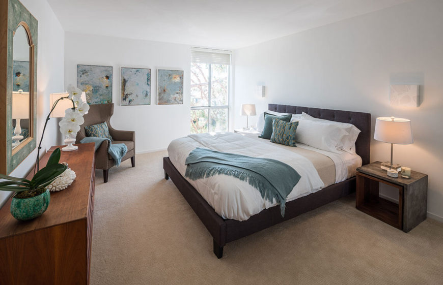 This bedroom is more liberal with the color, using various shades of teals to lighten up the neutral walls and bedding. Paintings replace personal photos, and an orchid adds a bit of organic, tropical beauty.