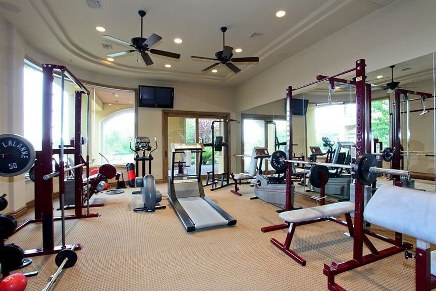 27 Luxury Home Gym Design Ideas for Fitness Buffs Home gym with plenty of free weight equipment.