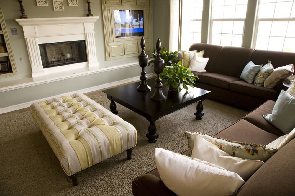 living room design with yellow ottoman