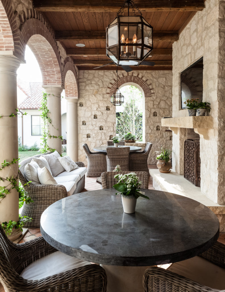 Moving outside, we see this heavily appointed patio, sheltered beneath a natural wood ceiling. Large stone fireplace overlooks two dining sets and an array of wicker frame, white cushion furniture. Moving outside, we see this heavily appointed patio, sheltered beneath a natural wood ceiling. Large stone fireplace overlooks two dining sets and an array of wicker frame, white cushion furniture.