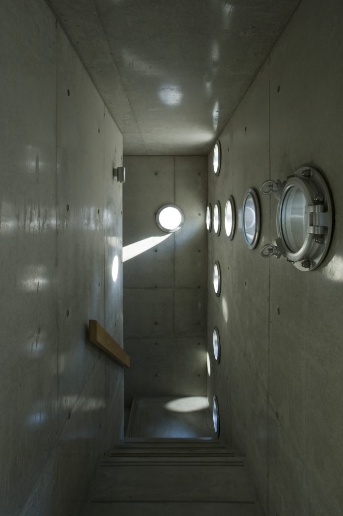 Looking down the staircase, we see another great example of the hole focused design playfully casting light throughout the home. Looking down the staircase, we see another great example of the hole focused design playfully casting light throughout the home.