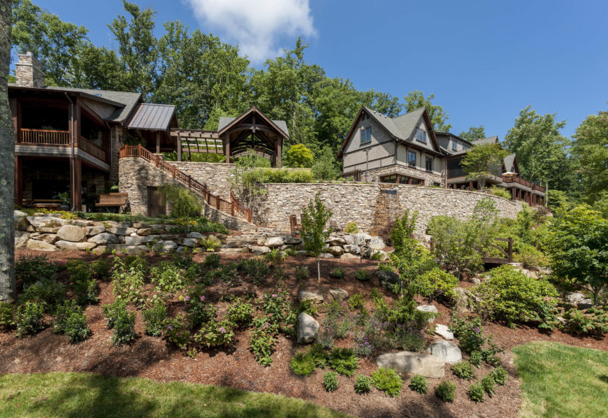 The entire estate is wrapped in immaculate landscaping, utilizing large stone pieces and the natural topography to striking effect. Water features can be seen running down the upper garden wall at center. The entire estate is wrapped in immaculate landscaping, utilizing large stone pieces and the natural topography to striking effect. Water features can be seen running down the upper garden wall at center.