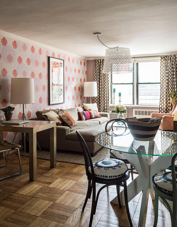 The living room evokes a sophisticated boutique hotel feel, which was accomplished by layering patterns, texture, and color, and incorporating an oversized light fixture as a fun yet dramatic point of interest. The living room evokes a sophisticated boutique hotel feel, which was accomplished by layering patterns, texture, and color, and incorporating an oversized light fixture as a fun yet dramatic point of interest.