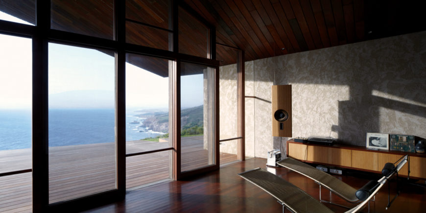 The music focused living room can be oriented toward the large covered deck, with the full height glass blurring the line between indoor and outdoor spaces. The music focused living room can be oriented toward the large covered deck, with the full height glass blurring the line between indoor and outdoor spaces.