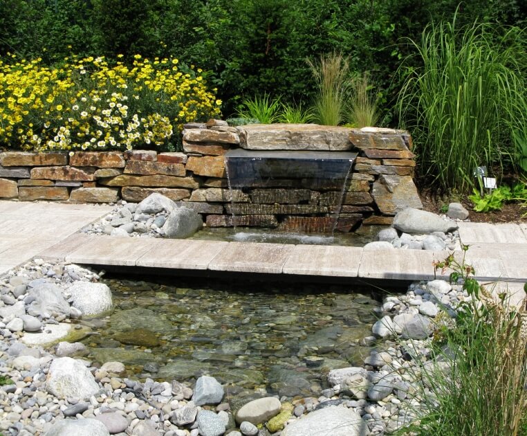 a shallow pond fed by a cascading fountain tucked into the stone edging a narrow - Koi Pond Designs Ideas a shallow pond fed by a cascading fountain tucked into the stone edging a narrow - Koi Pond Designs Ideas