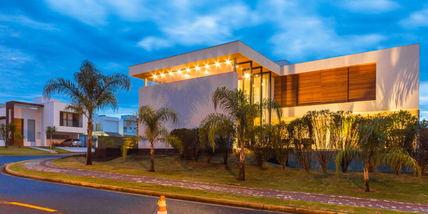Exterior spotlights and visible interior lights in the high rise living room announce the home's bold presence in this neighborhood. Exterior spotlights and visible interior lights in the high rise living room announce the home's bold presence in this neighborhood.