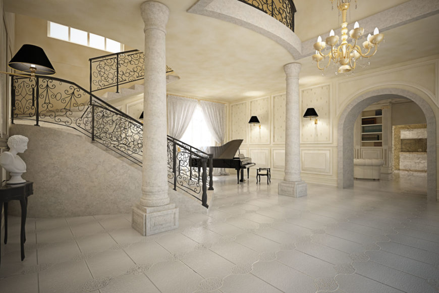 Entering the home, the grand spiral staircase commands attention over the open foyer space. Stone pillars, carved wood and gold leaf, and a singular black grand piano help make the elegant statement. Entering the home, the grand spiral staircase commands attention over the open foyer space. Stone pillars, carved wood and gold leaf, and a singular black grand piano help make the elegant statement.