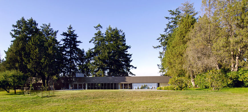 This distant shot highlights the dynamic interplay between the home and surrounding Douglas firs. The dark hued structure manages to partially retreat into the shadows from every angle, emerging in subtle fashion beneath the sunlight. This distant shot highlights the dynamic interplay between the home and surrounding Douglas firs. The dark hued structure manages to partially retreat into the shadows from every angle, emerging in subtle fashion beneath the sunlight.