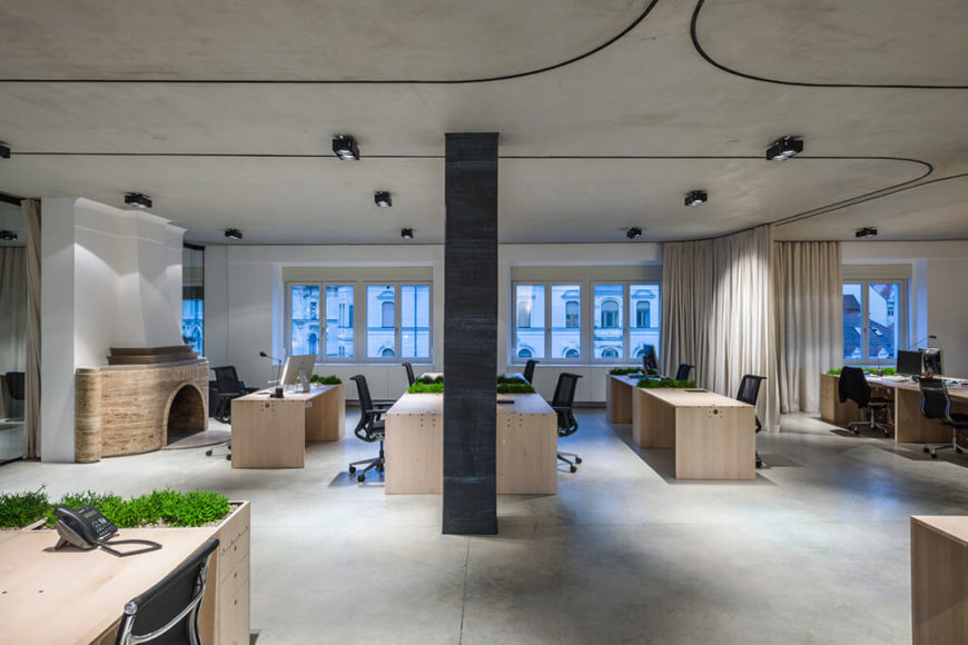 Pulling back to a wide angle, we see a grand sweep of the entire space with the curtains fully opened. Natural light pours in, enhanced by the bright wood of the desks and white walls, illuminating the broad open space. Pulling back to a wide angle, we see a grand sweep of the entire space with the curtains fully opened. Natural light pours in, enhanced by the bright wood of the desks and white walls, illuminating the broad open space.