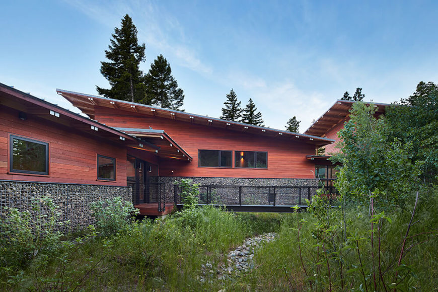 The beautiful front exterior of the retreat. The design was originally planned like a camp with three separate cabins for living, sleeping, and play. While planning the site, it became apparent that it would be more effective to create one structure with three distinct yet connected zones. Here you can better see each zone by the angle of the roof. The beautiful front exterior of the retreat. The design was originally planned like a camp with three separate cabins for living, sleeping, and play. While planning the site, it became apparent that it would be more effective to create one structure with three distinct yet connected zones. Here you can better see each zone by the angle of the roof.
