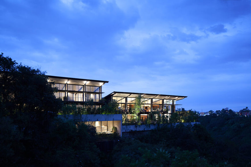 Here we see the pair of homes, nearly identical but staggered in their placement and shifted in their interior layout for privacy. The massive louvers hangt over full height glazing on this side of the home, providing comfort and expansive views. Here we see the pair of homes, nearly identical but staggered in their placement and shifted in their interior layout for privacy. The massive louvers hangt over full height glazing on this side of the home, providing comfort and expansive views.