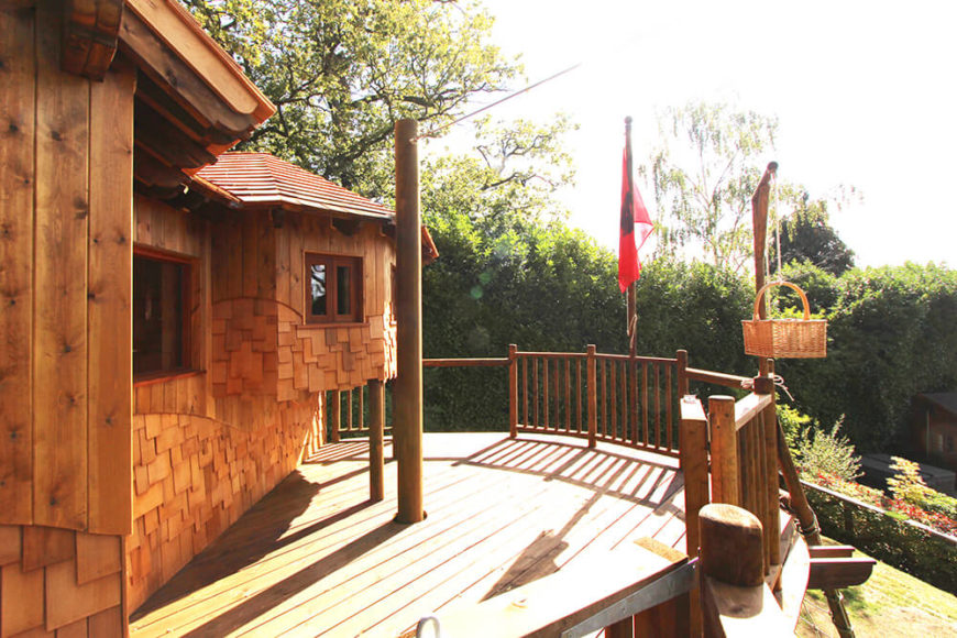 Here we see the expansive deck wrapping the treehouse, all in rich natural wood for a warm, inviting look. The zip wire connects here, as does the lift and load basket mounted to the right. Here we see the expansive deck wrapping the treehouse, all in rich natural wood for a warm, inviting look. The zip wire connects here, as does the lift and load basket mounted to the right.