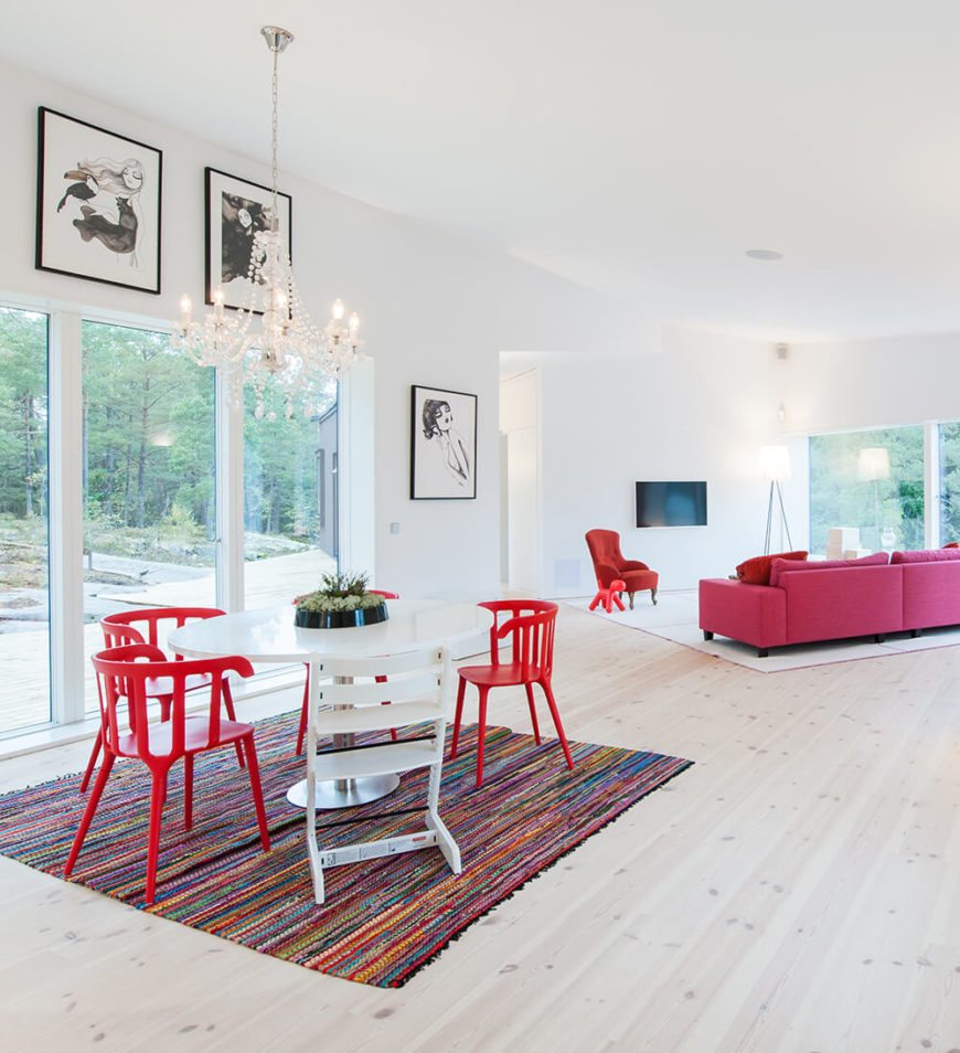 Moving inside, we witness the bold white walls and overall bright tone of the interior design, splashed with color courtesy of unique furniture choices. The open plan center of the home houses the living room and dining area, connecting directly to the kitchen. Moving inside, we witness the bold white walls and overall bright tone of the interior design, splashed with color courtesy of unique furniture choices. The open plan center of the home houses the living room and dining area, connecting directly to the kitchen.