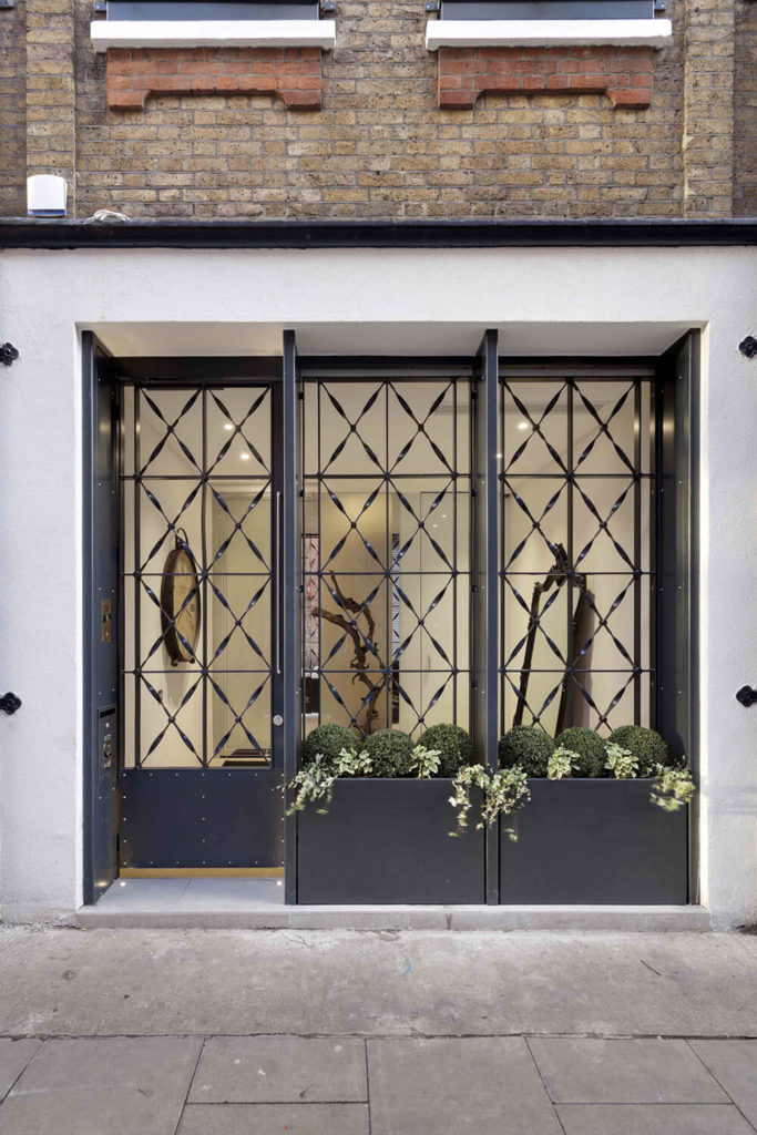 Here's a peek into the entryway, appearing at street level like the entrance to a classy shop or business. The decorative metal screen offers privacy and even space for a small garden. Here's a peek into the entryway, appearing at street level like the entrance to a classy shop or business. The decorative metal screen offers privacy and even space for a small garden.