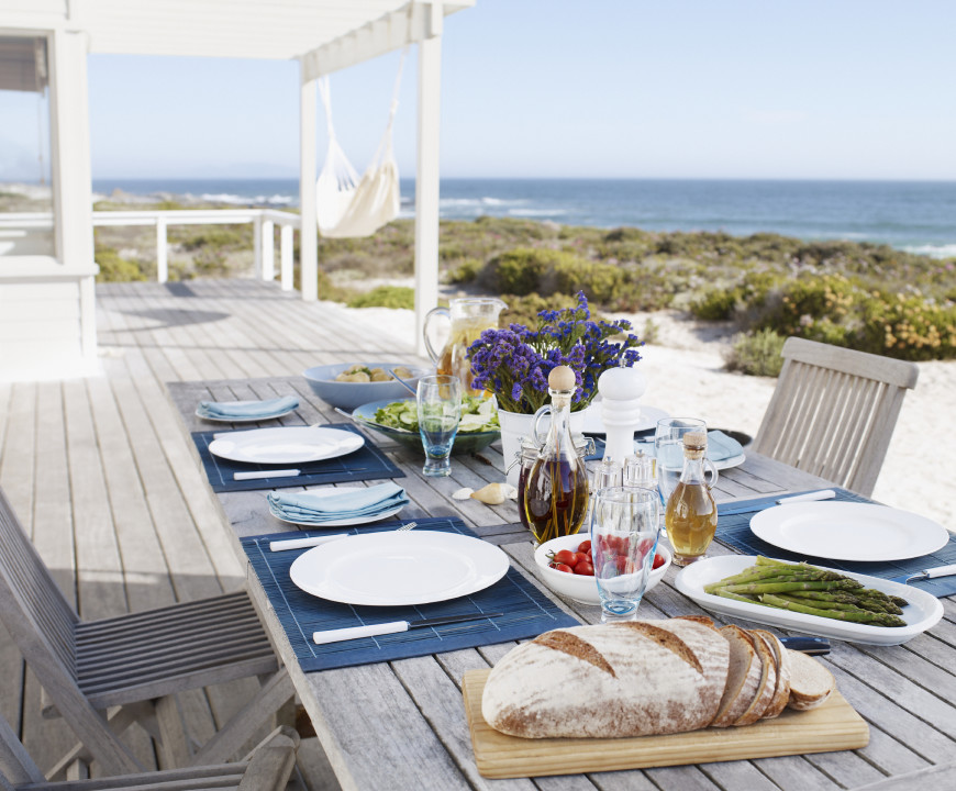 This table has a distressed and worn wooden look. This light and natural aesthetic replicates the feel of driftwood. It is the perfect look for a beachside deck.