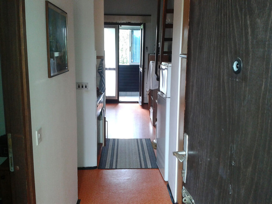 Upon entering the home before renovations, visitors were subject to a dated, claustrophobic foyer that looked through the entirety of the home. Red cork flooring draws the eye. Upon entering the home before renovations, visitors were subject to a dated, claustrophobic foyer that looked through the entirety of the home. Red cork flooring draws the eye.