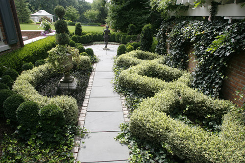 Here are some well maintained hedges making fancy shapes along this path leading to a statue. Hedge sculptures have a way of bringing some elegance and high end appeal to a garden. Here are some well maintained hedges making fancy shapes along this path leading to a statue. Hedge sculptures have a way of bringing some elegance and high end appeal to a garden.